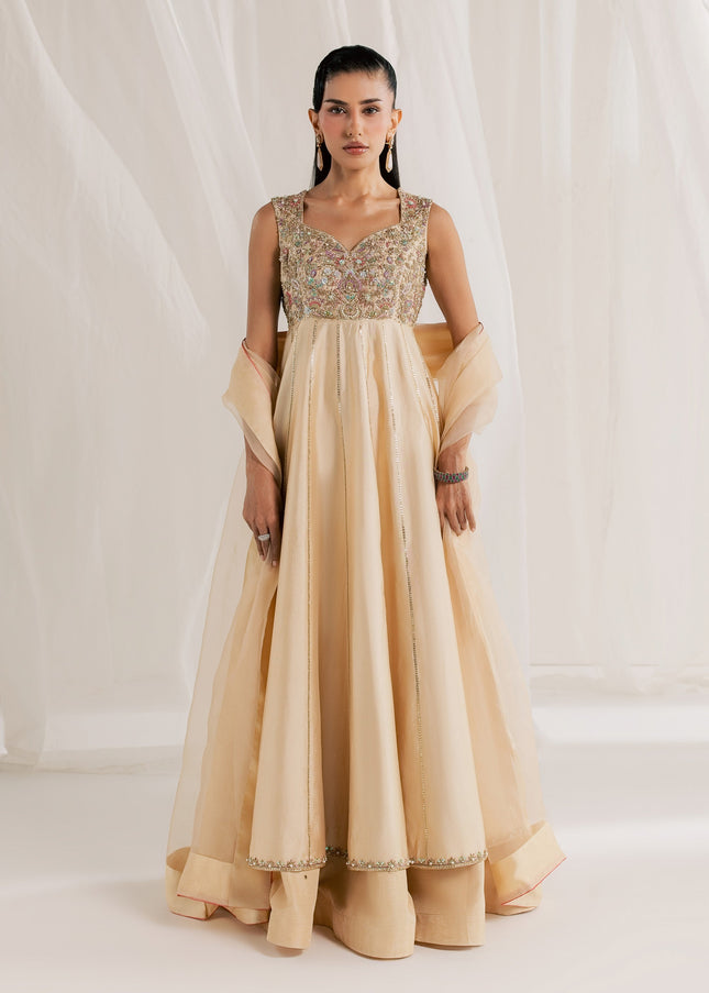 Model wearing Eraya Serene Aurora champagne peshwas lehnga with embellished yoke and organza dupatta