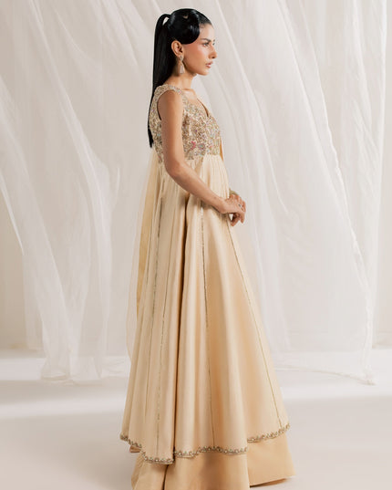 Side view of Eraya Serene Aurora champagne peshwas with flared lehnga and organza dupatta