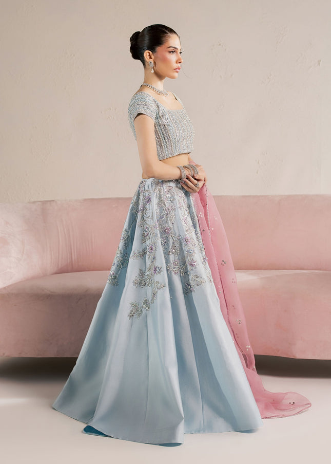 Model wearing Eraya Serene Camellia ice blue embellished lehnga choli with pink Mukesh organza dupatta