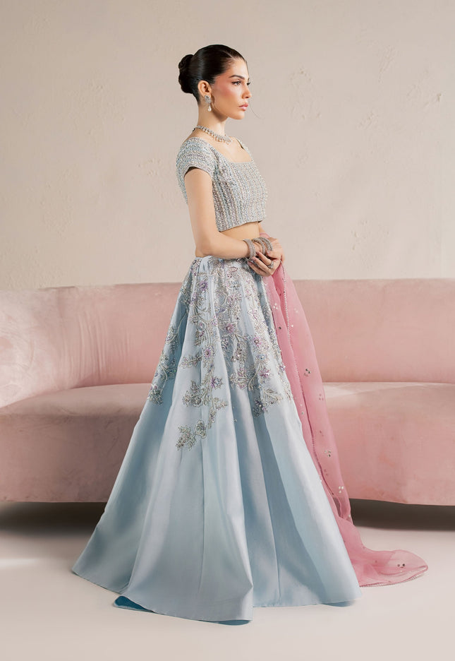 Model wearing Eraya Serene Camellia ice blue embellished lehnga choli with pink Mukesh organza dupatta