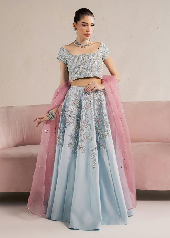 Eraya Serene Camellia ice blue lehnga choli shown front on with pastel floral embellishment