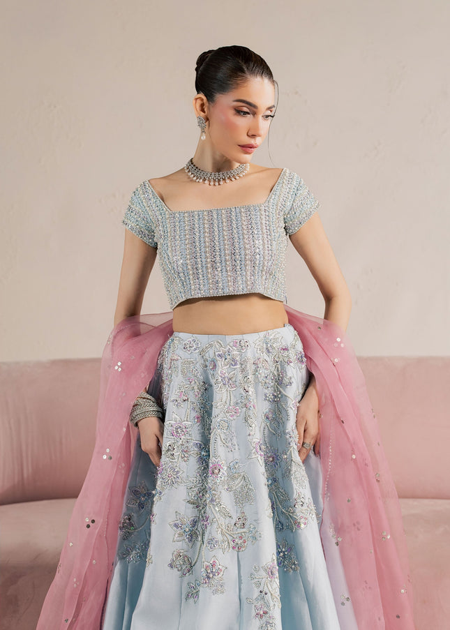 Eraya Serene Camellia ice blue embellished choli and lehnga with pink dupatta draped over the arm