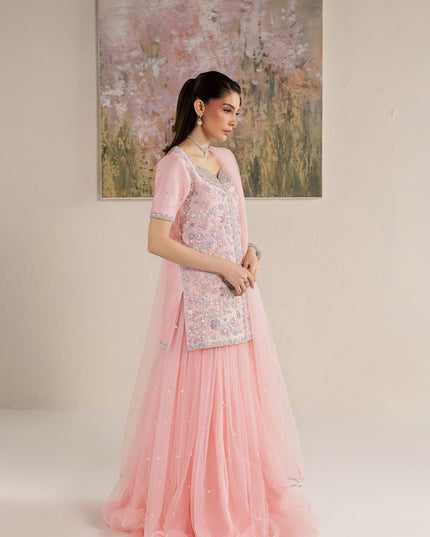 Side view of Eraya Serene Flora pink shirt and flared net lehnga with silver-edged dupatta