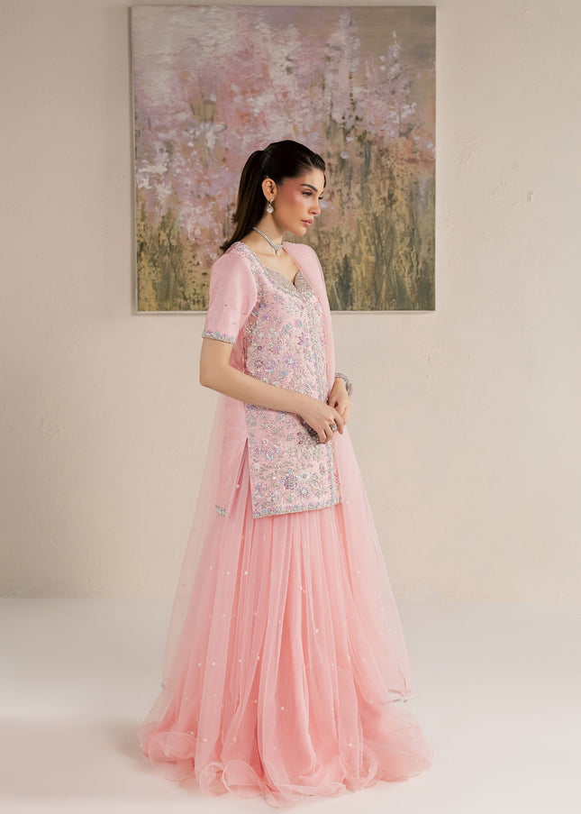 Side view of Eraya Serene Flora pink shirt and flared net lehnga with silver-edged dupatta