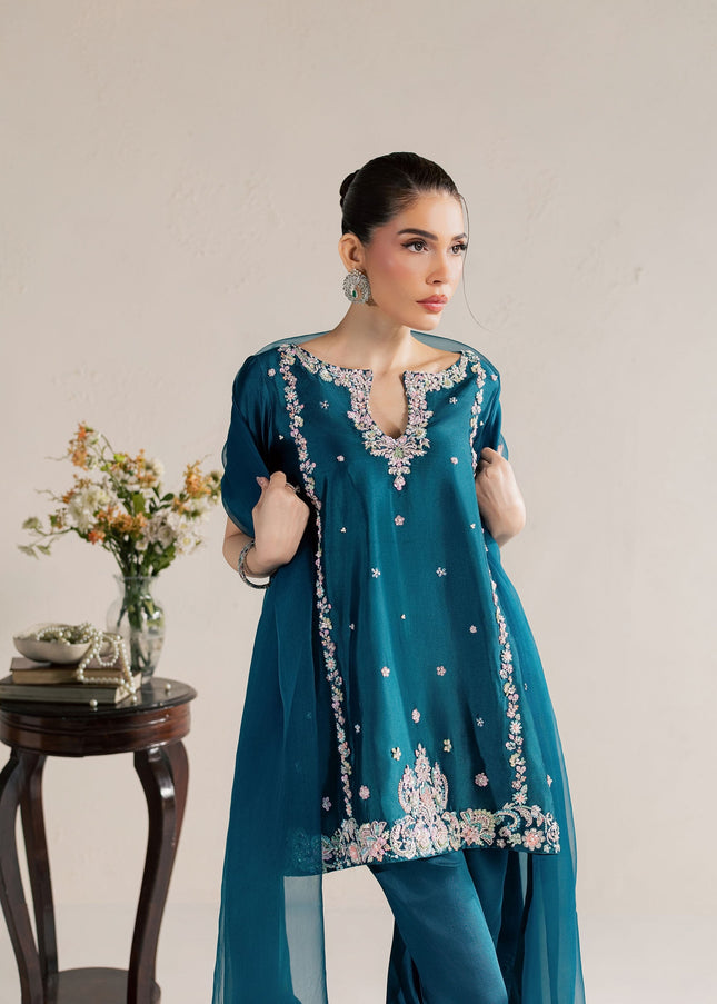 Model wearing Eraya Serene Opaline teal embellished peplum with tulip shalwar and organza dupatta