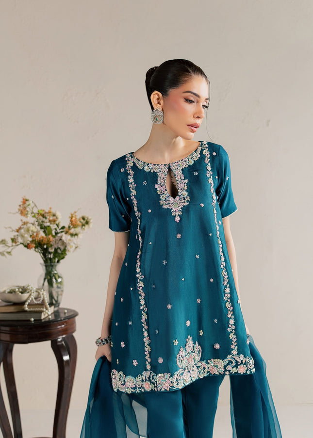 Eraya Serene Opaline teal peplum showing pastel sequin, pearl and crystal embellishment