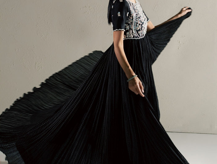 Eraya Serene Raven black peshwas in motion showing the flowing crushed silk flare