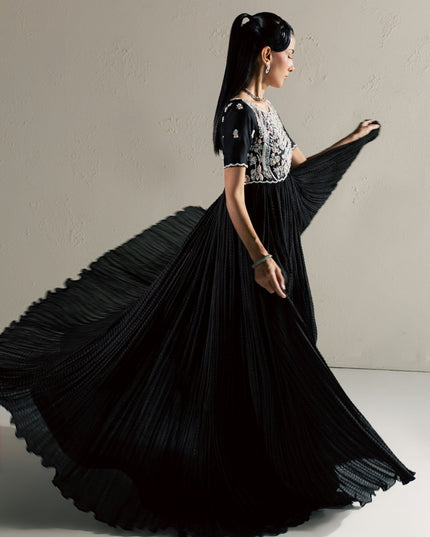 Eraya Serene Raven black peshwas in motion showing the flowing crushed silk flare